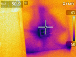 Thermal imaging of a wall outlet reveals a cold area around the outlet, reaching down to 50 degrees (F), while areas around reach up to 63 degrees (F).