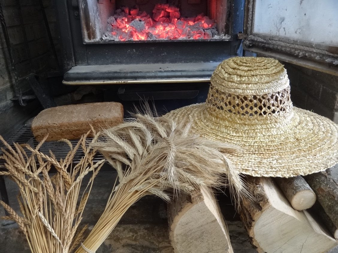 Theo Wiederkehr made this sun hat out of straw from spelt he grew. The loaf of sour dough bread was also made using spelt and rye from the farm. It was baked in the family’s wood stove using firewood collected nearby. Photo by Andre Wiederkehr.